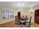 Elegant dining room with hardwood floors, a chandelier, and plantation shutters for a bright, inviting space at 1236 Whitlock Ridge Sw Dr, Marietta, GA 30064