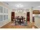 Dining area with a round table, chandelier lighting, plantation shutters, and built-in cabinets at 1236 Whitlock Ridge Sw Dr, Marietta, GA 30064