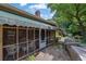 Exterior view of home showing the screened porch with awning, stone patio, and beautiful landscaping at 1236 Whitlock Ridge Sw Dr, Marietta, GA 30064