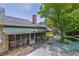 View of exterior with screened porch, stone patio, and manicured yard, showcasing outdoor living spaces at 1236 Whitlock Ridge Sw Dr, Marietta, GA 30064