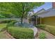 Lush backyard with mature trees, outdoor seating, and a covered porch, creating a peaceful outdoor oasis at 1236 Whitlock Ridge Sw Dr, Marietta, GA 30064
