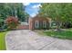 Brick home boasts manicured lawn, mature tree, and extended driveway, creating curb appeal at 1236 Whitlock Ridge Sw Dr, Marietta, GA 30064