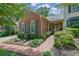 Charming brick home featuring a landscaped yard and inviting front porch with a stone bench at 1236 Whitlock Ridge Sw Dr, Marietta, GA 30064