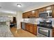 Modern kitchen with stainless steel appliances, granite countertops, and warm-toned wooden cabinets at 1236 Whitlock Ridge Sw Dr, Marietta, GA 30064