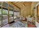Inviting screened porch with brick flooring, ceiling fan, and comfortable wicker furniture for relaxing and enjoying the outdoors at 1236 Whitlock Ridge Sw Dr, Marietta, GA 30064