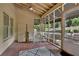 Relaxing screened porch featuring brick flooring, ceiling fan, and access to outdoor area with well-manicured landscaping at 1236 Whitlock Ridge Sw Dr, Marietta, GA 30064