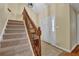Well-lit staircase leading to the upper level, featuring carpeted steps and wooden railings at 1236 Whitlock Ridge Sw Dr, Marietta, GA 30064