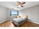 Cozy bedroom featuring hardwood floors, ceiling fan, and a large window for natural light at 1501 Clairmont Rd # 1213, Decatur, GA 30033