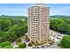 A mid-level exterior view of this brick highrise featuring well-maintained landscaping and convenient parking at 1501 Clairmont Rd # 1213, Decatur, GA 30033