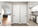 A hallway that grants access to the living room and a compact kitchen with modern appliances at 1501 Clairmont Rd # 1213, Decatur, GA 30033