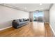 A well lit living room shows the hardwood floors and a sliding glass door to the balcony at 1501 Clairmont Rd # 1213, Decatur, GA 30033