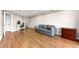 Open-concept living room featuring hardwood floors, a sleeper sofa, and a dedicated office space at 1501 Clairmont Rd # 1213, Decatur, GA 30033