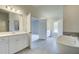 Bright bathroom features double vanity, large tub and tile flooring at 162 Haverling Pass, Hampton, GA 30252