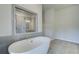 Bathroom featuring a tiled shower and freestanding soaking tub at 162 Haverling Pass, Hampton, GA 30252