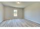 Empty bedroom with neutral paint, a window, and hardwood floors at 162 Haverling Pass, Hampton, GA 30252