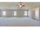 Expansive bedroom features neutral tones, tray ceiling, recessed lights and fan at 162 Haverling Pass, Hampton, GA 30252