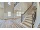 Grand two-story foyer with staircase and open view to the dining room with elegant details at 162 Haverling Pass, Hampton, GA 30252