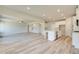 Open kitchen and living area with hard wood floors and stainless steel appliances and an island at 162 Haverling Pass, Hampton, GA 30252