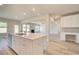 View of an island with stainless steel dishwasher and sink in a new kitchen with hardwood floors at 162 Haverling Pass, Hampton, GA 30252