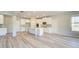 Bright kitchen boasts an island, white cabinets, stainless steel microwave, and hardwood floors at 162 Haverling Pass, Hampton, GA 30252