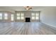 Spacious living room featuring hardwood floors, fireplace, and large windows at 162 Haverling Pass, Hampton, GA 30252
