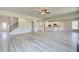 Large open concept kitchen and living room with hardwood floors and neutral paint at 162 Haverling Pass, Hampton, GA 30252