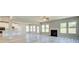 Open-concept living room with fireplace, hardwood floors, and ample natural light at 162 Haverling Pass, Hampton, GA 30252