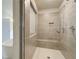 Bathroom walk-in shower features a built-in bench and rainfall shower head at 162 Haverling Pass, Hampton, GA 30252