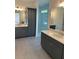 Elegant bathroom featuring dual vanities with marble countertops and a glass-enclosed shower at 241 Saratoga Dr, Acworth, GA 30102