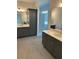 Elegant bathroom featuring double vanities, stylish cabinets, and a glass-enclosed shower at 241 Saratoga Dr, Acworth, GA 30102