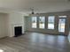 Bright living room features a fireplace, ceiling fan, and large windows at 241 Saratoga Dr, Acworth, GA 30102