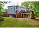 A two-story traditional home boasts a multi-level deck and stone fireplace, perfect for outdoor gatherings at 265 Dogwood Walk Ln, Norcross, GA 30071