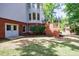 The backyard of the home features access to the basement, a stone fireplace, and a stained deck at 265 Dogwood Walk Ln, Norcross, GA 30071