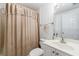 Clean bathroom featuring a shower with curtain, a vanity with sink, and neutral color scheme at 265 Dogwood Walk Ln, Norcross, GA 30071