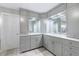 Elegant bathroom with white cabinets, marble countertops, and large mirrors at 265 Dogwood Walk Ln, Norcross, GA 30071