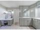 Bathroom with white cabinets, marble countertops, makeup counter and large mirrors at 265 Dogwood Walk Ln, Norcross, GA 30071