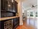 Elegant butler's pantry with wine fridge and cabinetry, leading to sitting room at 265 Dogwood Walk Ln, Norcross, GA 30071
