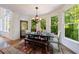 Dining room filled with natural light, wooden table, and view of the backyard at 265 Dogwood Walk Ln, Norcross, GA 30071