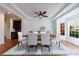 Elegant dining room with hardwood floors, tray ceiling, modern fan, and bright natural light at 265 Dogwood Walk Ln, Norcross, GA 30071