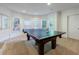 Game room with a full-sized ping pong table and natural light, perfect for entertaining guests at 265 Dogwood Walk Ln, Norcross, GA 30071