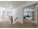 Upstairs hallway leading into a bedroom featuring a tray ceiling at 265 Dogwood Walk Ln, Norcross, GA 30071