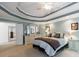 Large bedroom with a tray ceiling, recessed lighting, and a ceiling fan at 265 Dogwood Walk Ln, Norcross, GA 30071