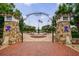 The entrance to Lillian Webb Park features brick pillars, ornate gates, and an American flag at 265 Dogwood Walk Ln, Norcross, GA 30071