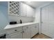 Well-equipped wet bar area featuring sleek white cabinetry, a sink, and ample counter space at 265 Dogwood Walk Ln, Norcross, GA 30071