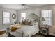 Inviting bedroom with a comfortable bed, decorative pillows, and a sunburst mirror above the headboard at 3330 W Shadowlawn Ne Ave, Atlanta, GA 30305