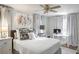 Bright bedroom featuring a comfortable bed, white linens, decorative pillows, and a dedicated desk area at 3330 W Shadowlawn Ne Ave, Atlanta, GA 30305