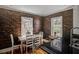 Bright dining room with hardwood floors, exposed brick wall and table with chairs by the windows at 3330 W Shadowlawn Ne Ave, Atlanta, GA 30305