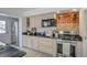 Stylish kitchen featuring stainless steel appliances, white cabinets, granite countertops and exposed brick wall at 3330 W Shadowlawn Ne Ave, Atlanta, GA 30305