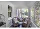 Cozy sunroom featuring woven chairs, a small table, large windows, and a view of the outdoors at 3330 W Shadowlawn Ne Ave, Atlanta, GA 30305