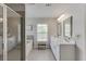 Elegant bathroom featuring a glass enclosed shower, a soaking tub, and a double vanity at 4650 Silver Meadow Dr, Buford, GA 30519